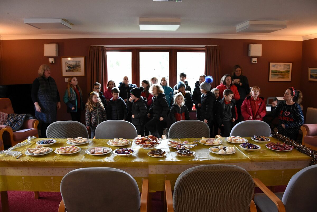 Young carolers entertain at retirement complex