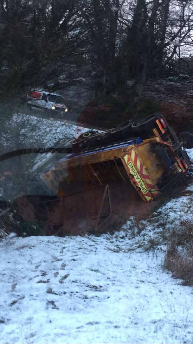 Driver taken to hospital after gritter overturns on icy road