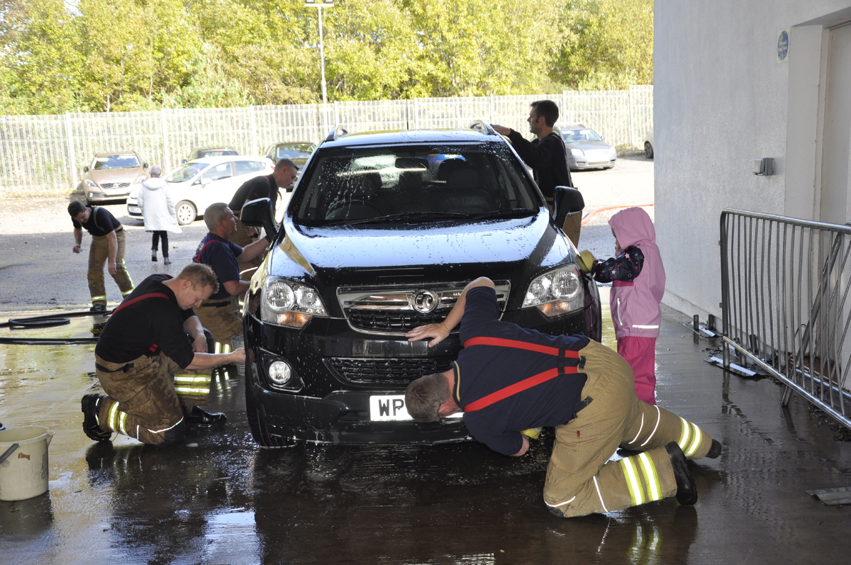 Firefighters clean up for charity close to home