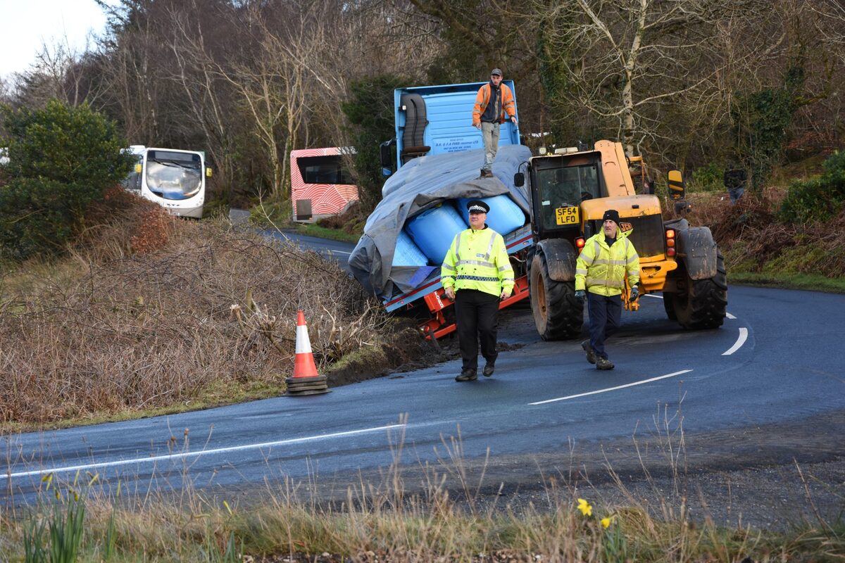 Lorry slips from road at sharp bend