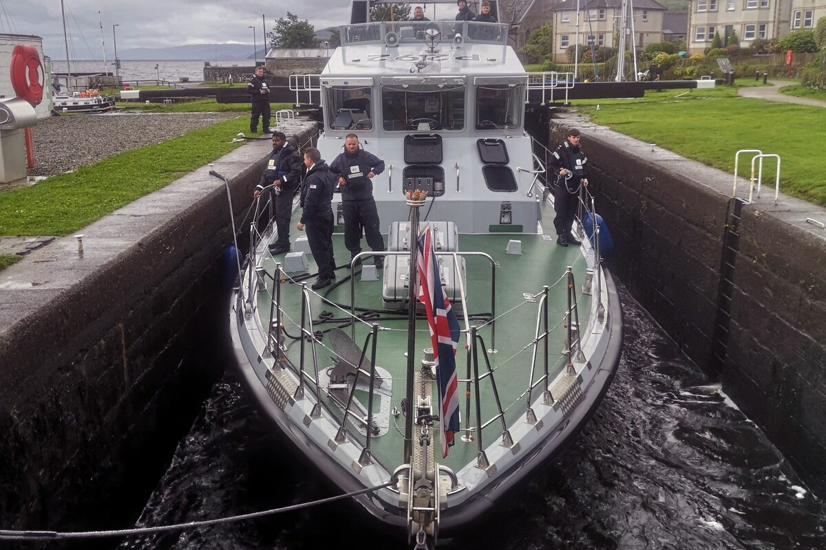 Warship squeezes through Crinan Canal - just