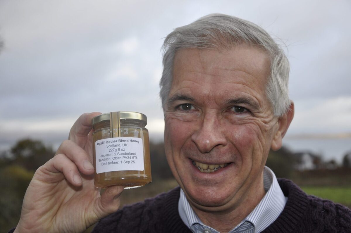 Master bee farmer Steven Sunderland with his honey labelled in braille