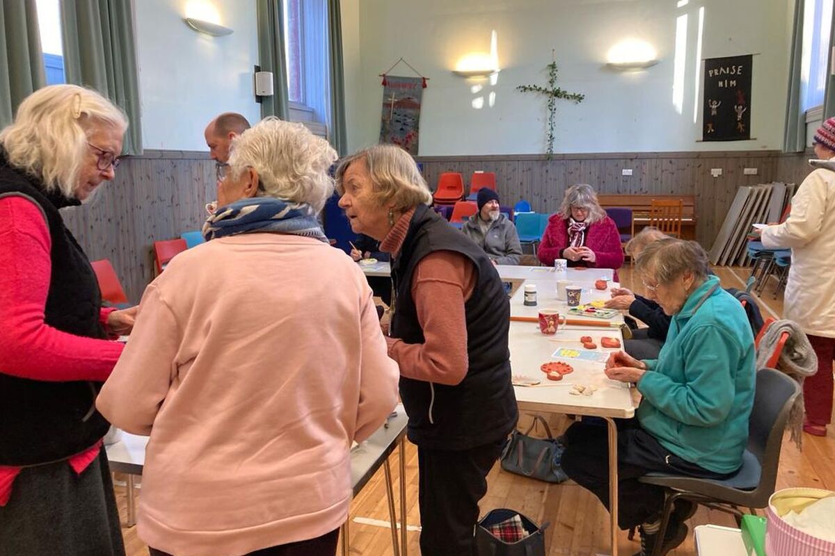 Members chat over a coffee as others get on with their crafts.