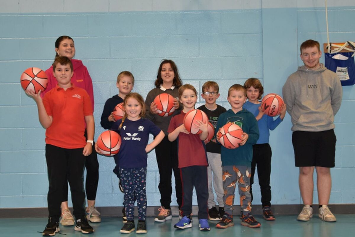 P1 to P7 pupils enjoy a basketball session with coaches Isabella Reid and Scott Murray.