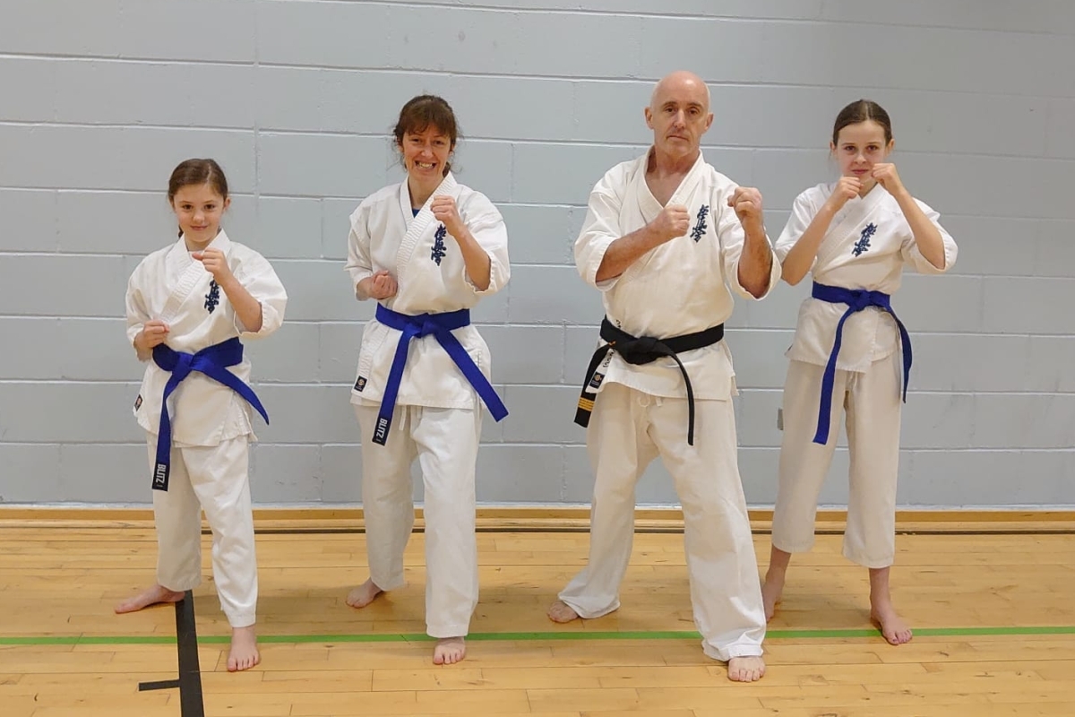 Lochgilphead karate blue belts, Neve Taylor, Karen Taylor and Ellen Oates with instructor Wallace Simpson. Photograph: The Independent Kyokushinkai Karate Union