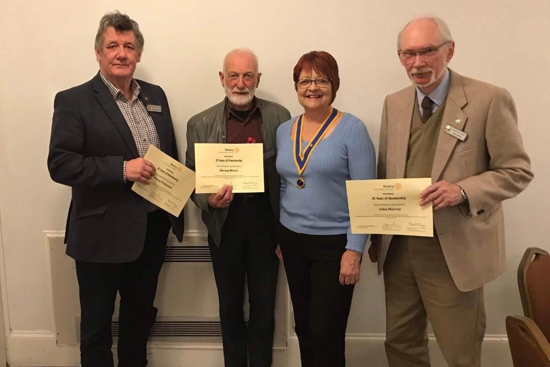 Lochaber Rotary President Flora McKee presented, from left, Finlay Finlayson, George Bruce and John Harvey with their long service certificates.