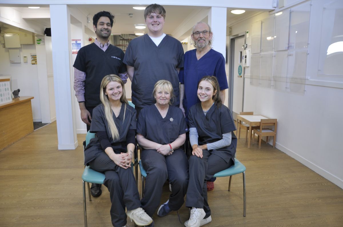 All smiles from dentists Abdul Aslam-Pervez and Stewart Wright with their practice staff in Shore Street.