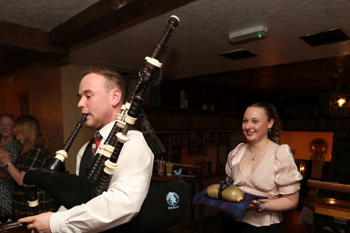 Jamie MacGregor pipes in the haggis carried by Olivia MacLeod at the SNP Burns Supper at Cuan Mhor. Photograph: Kevin McGlynn