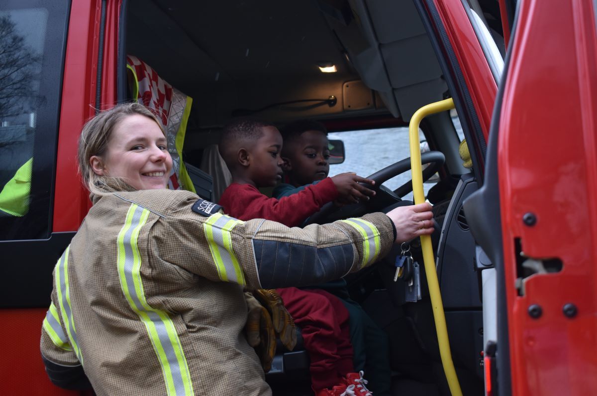 Four-year-olds Tadiwa and Tamuda see a future in the fire service with Kinlochleven community fire fighter Alice Shoulder in attendance.