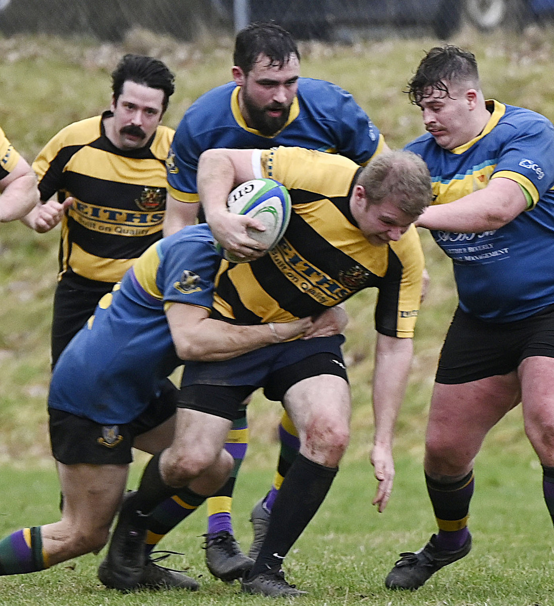 Lochaber's Liam Ryan pushes through a strong challenge. Photograph: Iain Ferguson, alba.photos.