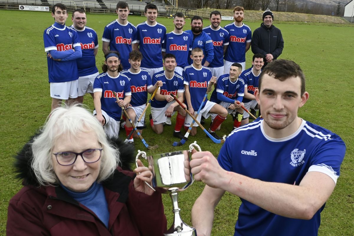 Drew Ferguson's mother Sheila presents the memorial trophy to Kyles captain Scott MacDonald. Photograph: Iain Ferguson, alba.photos