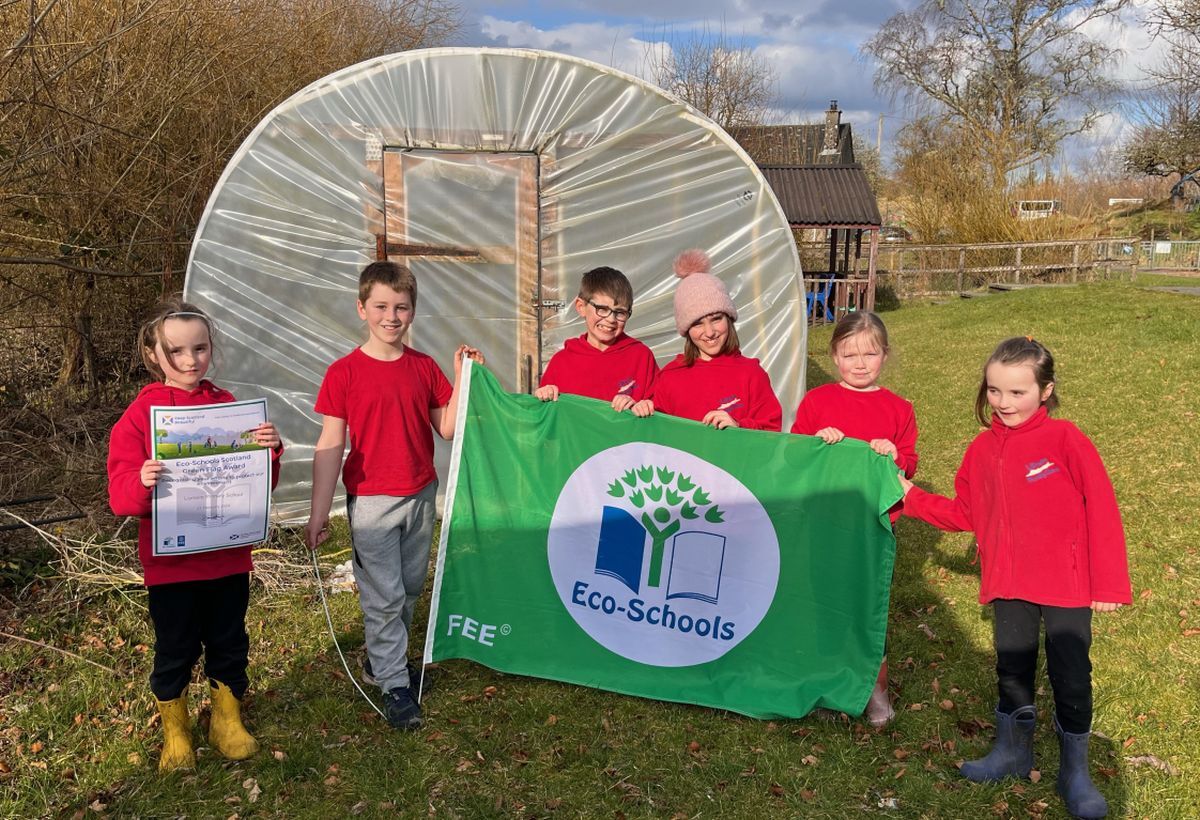 Pupils at Lismore School raising the eco flag in their garden in 2024.