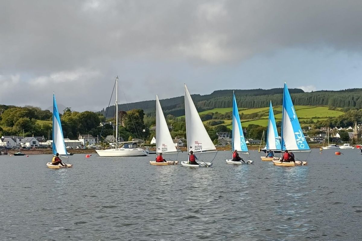 Young sailors enjoy sailing in the calm waters of Lamlash Bay.