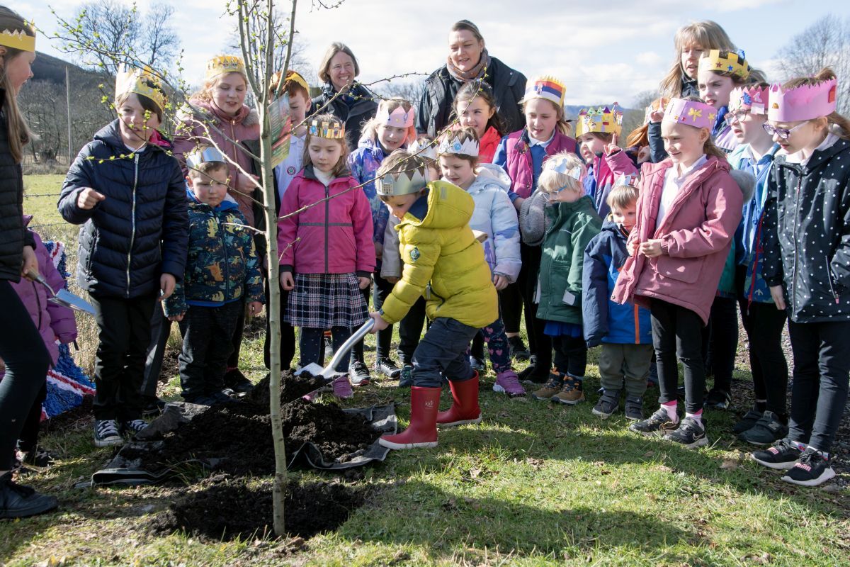 Strath of Appin Primary School pupils laid the first earth around the tree, as Union Flag banners and paper crowns made by the schoolchildren were displayed.