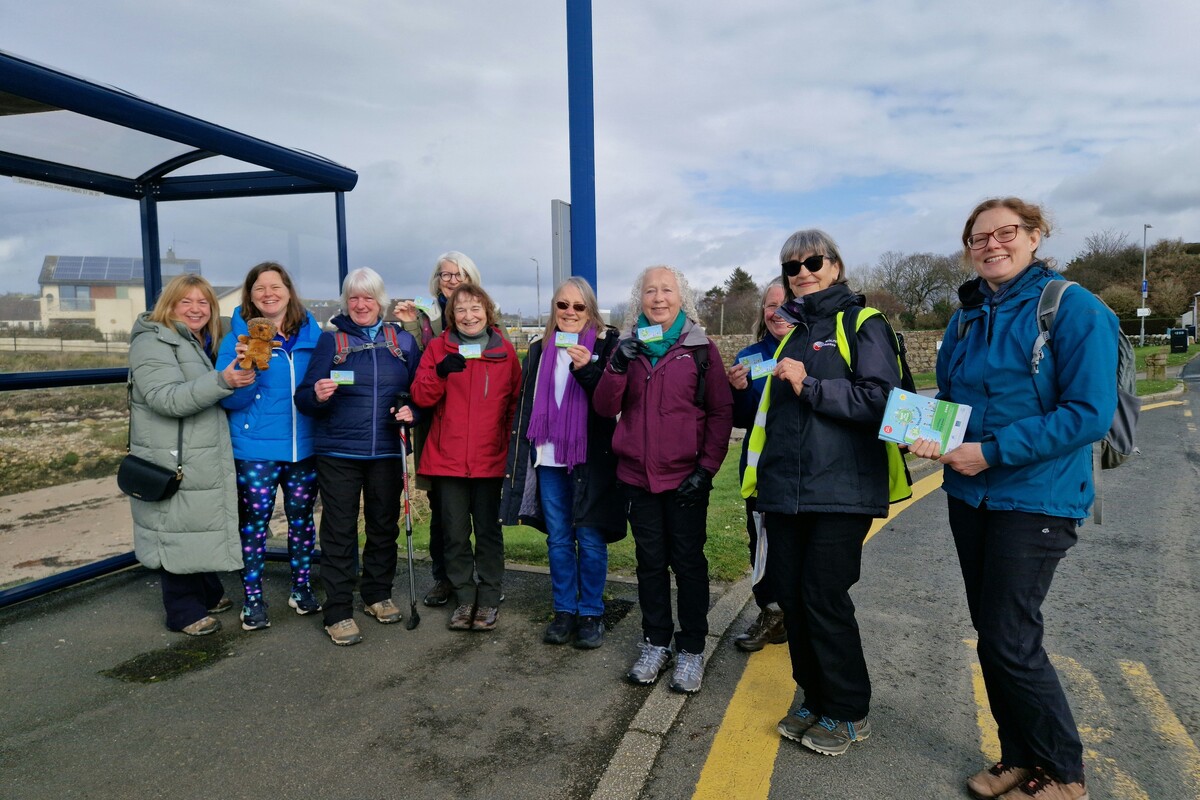 Eco Savvy’s Juliette Walsh, right, with health walk leader Diana Turbett next to her and a group of walkers in Blackwaterfoot. Photograph: Eco Savvy. 