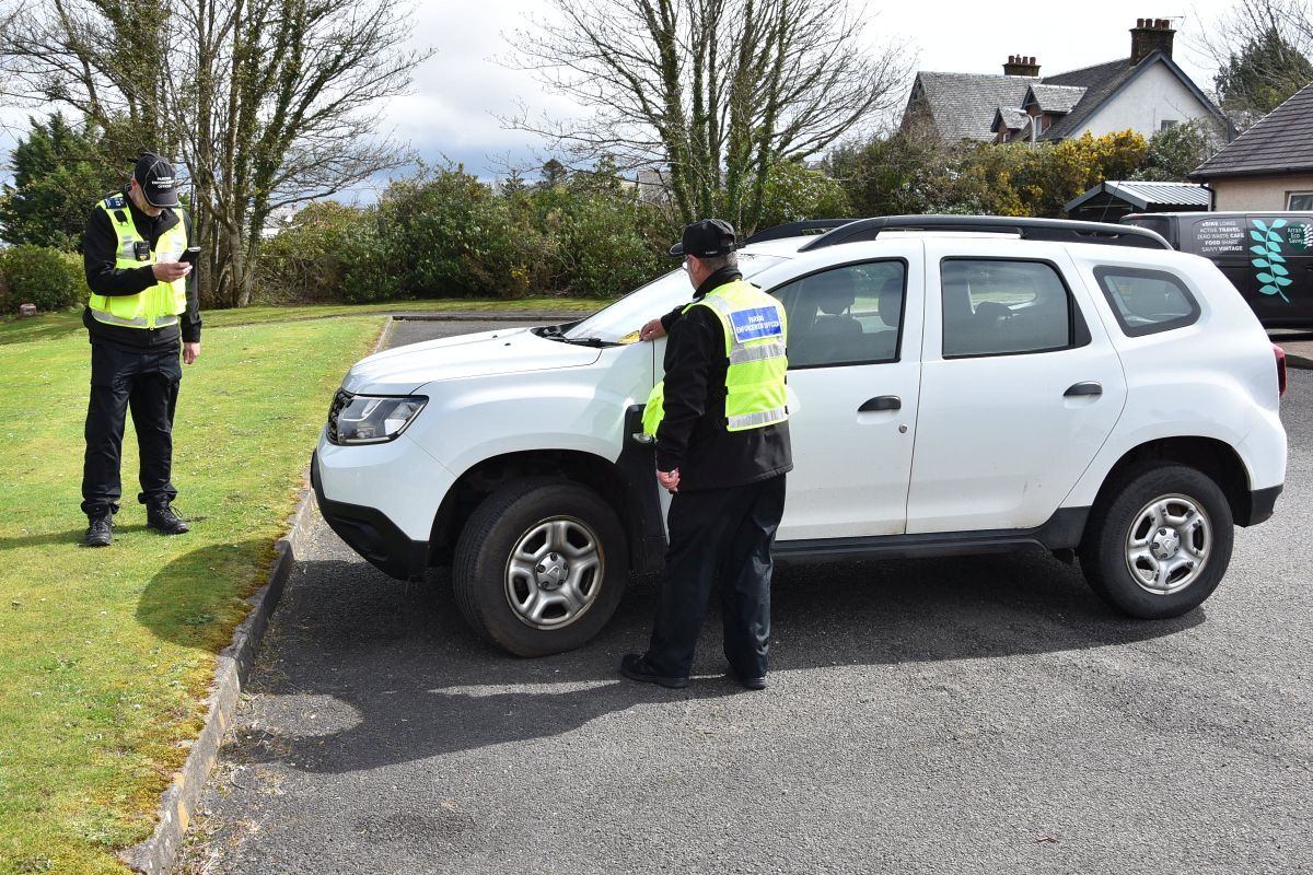 Parking enforcement officers demonstrate how they will issue a PCN during a recent visit to the island.