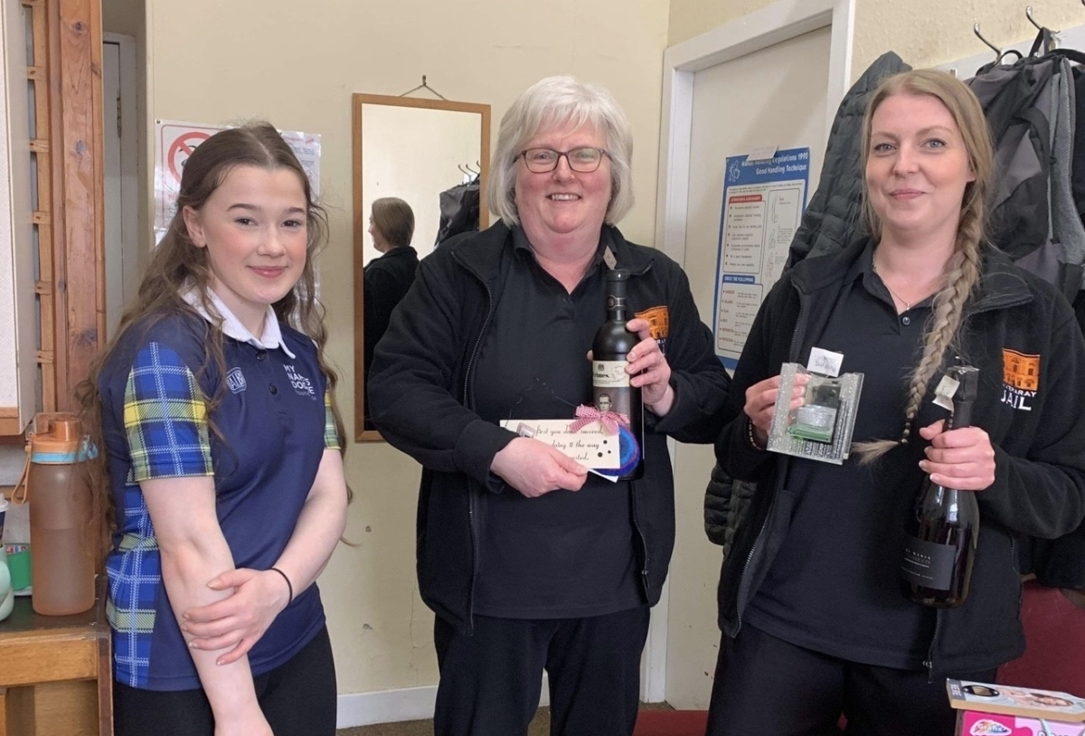 Feorlin Renton delivering a fair few raffle prizes to Inveraray Jail to staff Joanne Fraser and Rachael Swailes. Photograph: Meg Renton