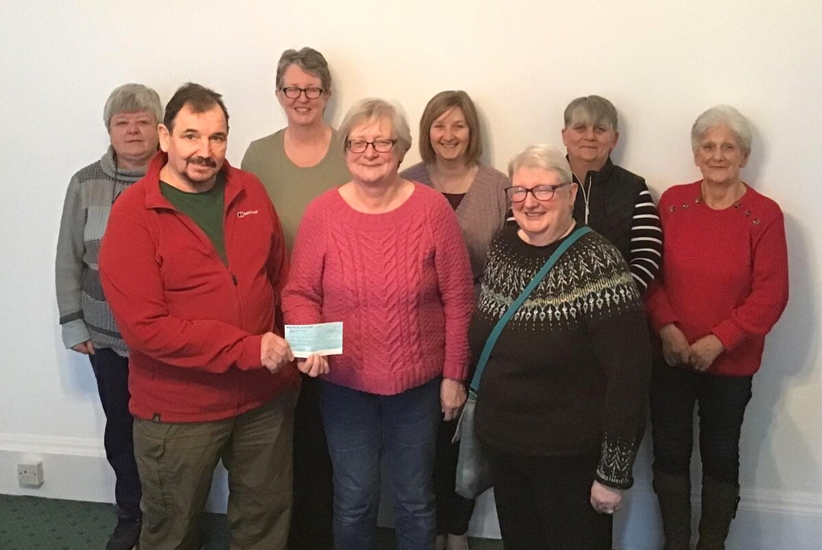 David Millward, front left, and Jo Goudie, front right, from Machrihanish Seabird and Wildlife Observatory receiving a cheque from the Nimble Fingers members.