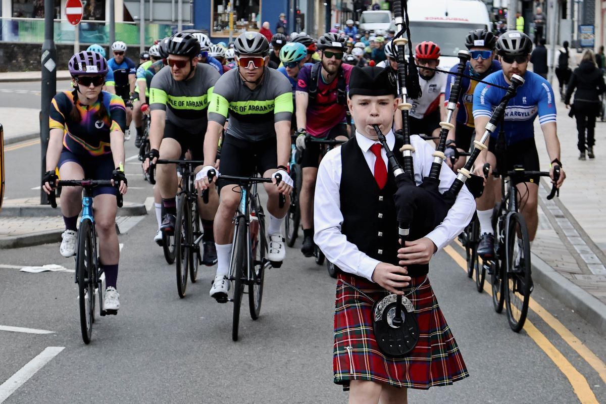 Piper Alfie Robertson leads the riders down George Street from Oban Distillery before setting off. Photograph: Kevin McGlynn.