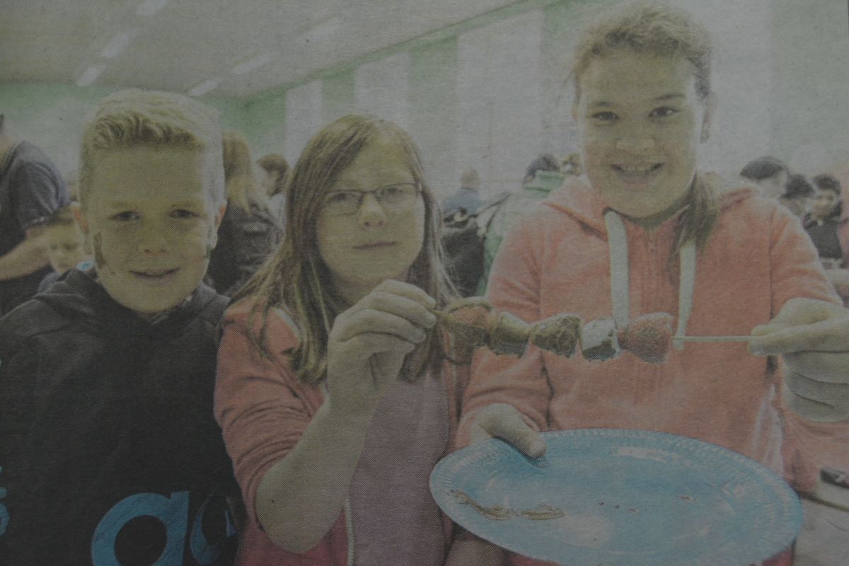 2014: Arran MacFadyen, Ena Wood and Erin MacFadyen sample some of the delicious food on sale at the Lochyside RC Primary School annual summer fete. Photograph: lain Ferguson, The Write Image.