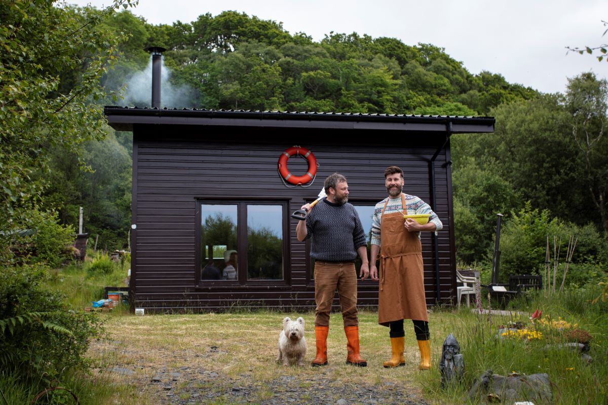 Peter MacQueen, left, his partner Coinneach MacLeod and Seòras the Westie at the hut.