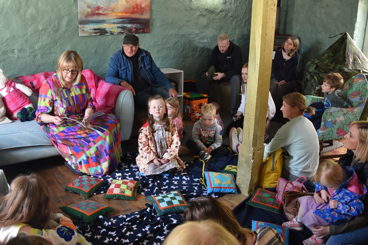 Children listen attentively as Alison reads from the new book, Corrie’s Paper Capers.