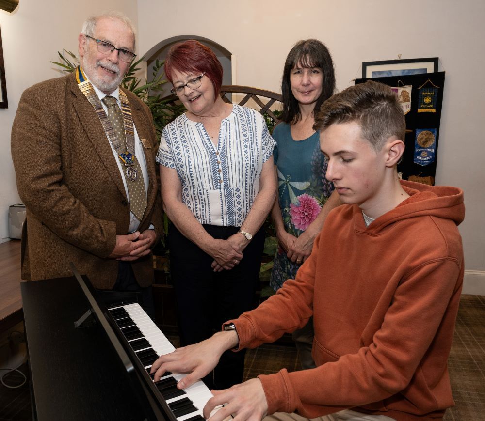 Jack Bungey with Rotary President Malcolm MacRaild, Immediate Past-President Flora McKee and his Mum Laura. Photo courtesy of Iain Ferguson.