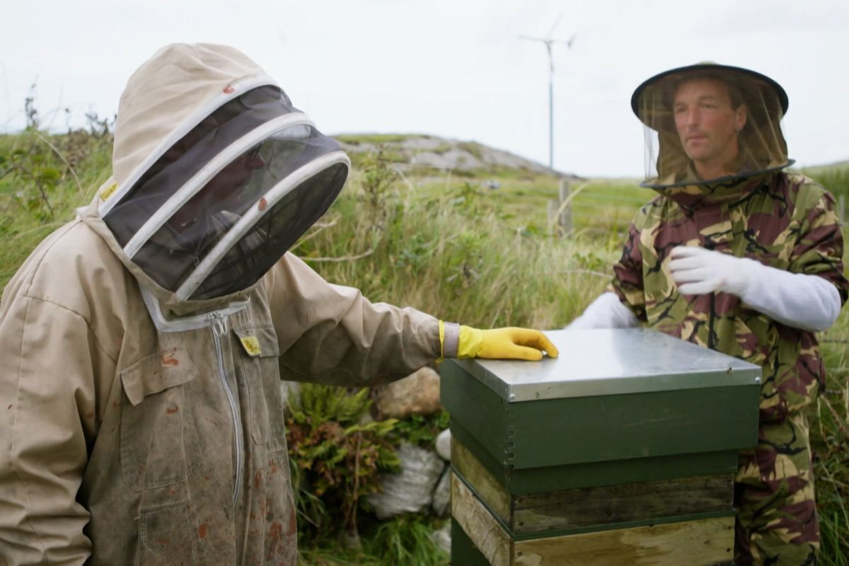 CalMac seaman Graeme, left, and his neighbour Ron check a beehive on Coll. Photograph: BBC Scotland/IWC Media