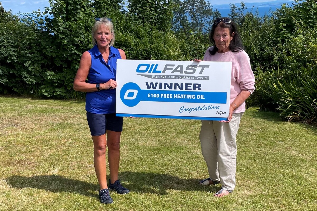 Oilfast’s Gay MacKay presents Don Hunter with her £100 kerosene voucher. Photograph: Oilfast. Oilfast’s Gay MacKay presents Don Hunter with her £100 kerosene voucher. Photograph: Oilfast.