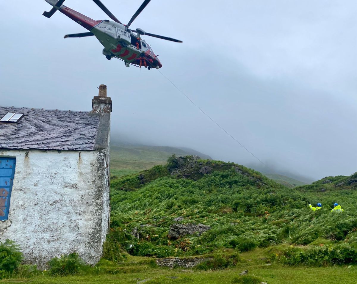 The casualty is winched aboard the HM Coastguard helicopter. Photograph: Arran Coastguard Rescue Team.