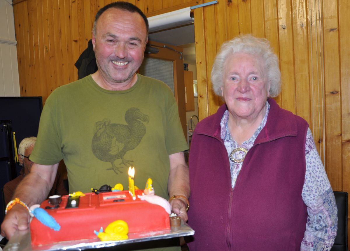 Luing's retired postie Colin Brown with former island post mistress Pam Shairp at the Cullipool Hall surprise party.