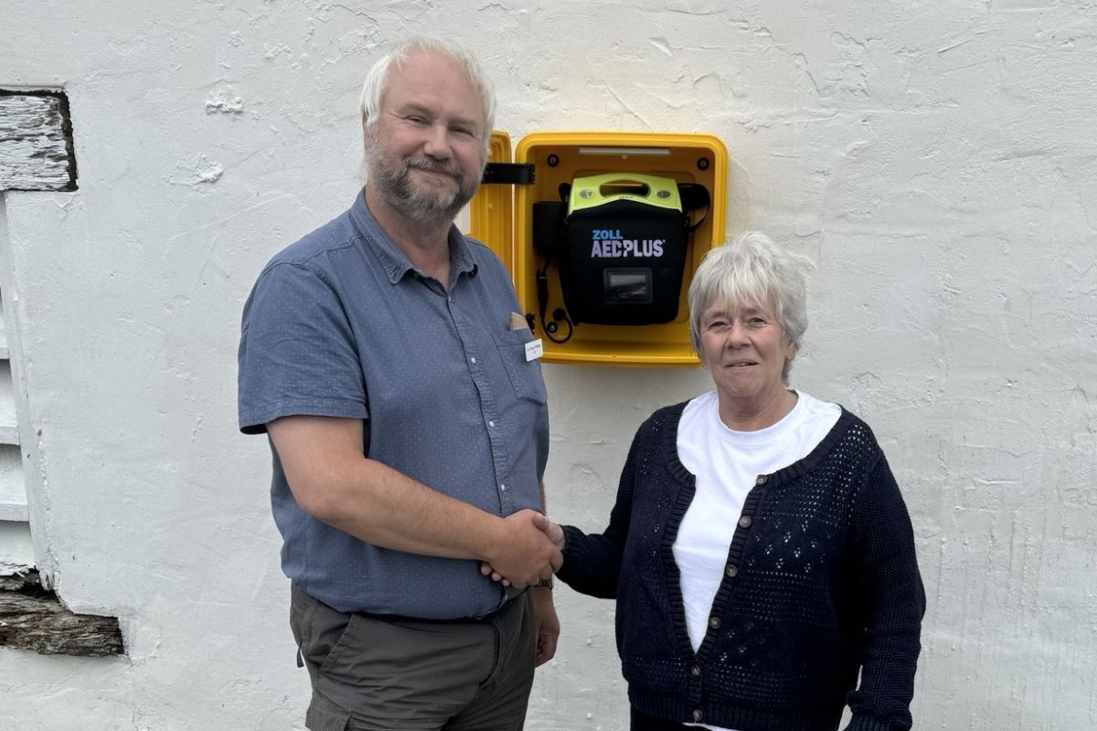 Colonsay GP Simon Willetts and Liz McNichol with the defibrilltor newly fitted on the shed wall at Kilchattan.