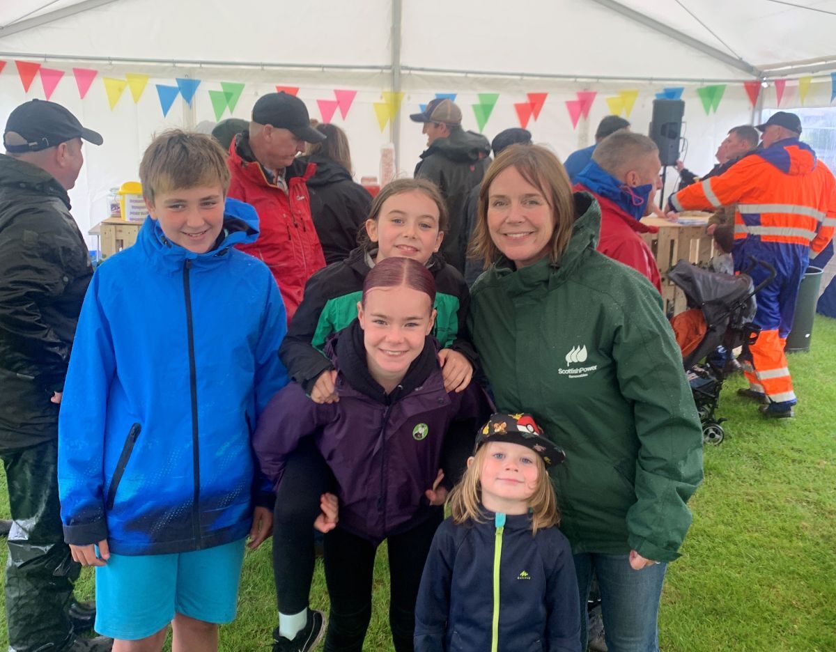 SPR's Debs Bryce taking cover under the new marquee at the Port Elen sports day alongside young people from Jura. Photograph: SPR