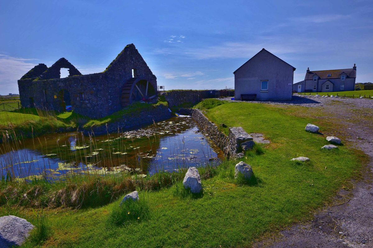 The farmhouse with its nearby waterwheel and the barn conversion hostel on Tiree is being advertised as a rare lifestyle business opportunity.