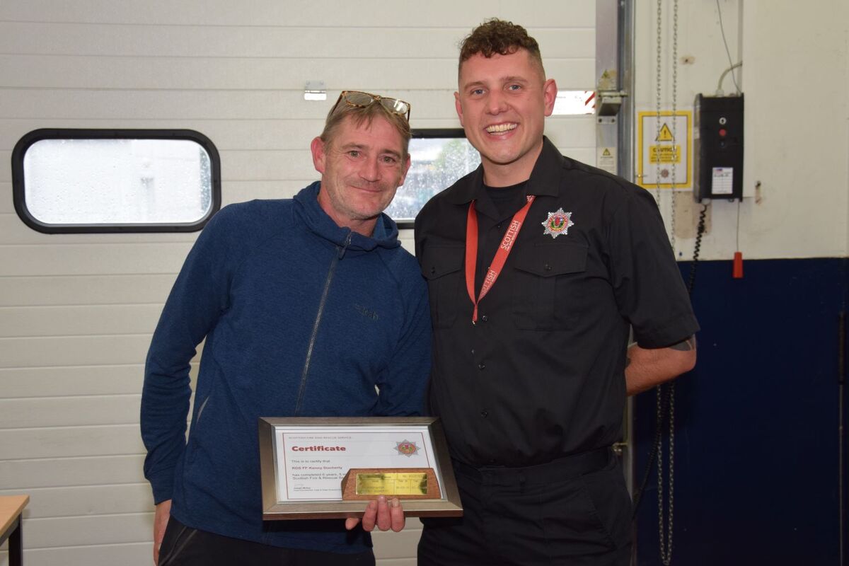 Kenny Docherty, left, with firefighter Jamie Morris, completed six years and five months' service.