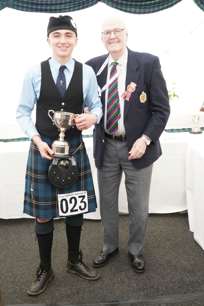 Rio Arkell, runner up in the Local Juvenile March competition, receiving his trophy from judge Jim Henderson. Photograph: Pure West Media.