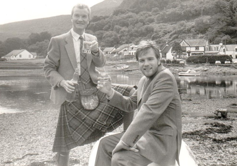 Andrew Currie and Ewan McGregor toast the good health of Arran single malt on the shore of Lochranza castle in 1998. 