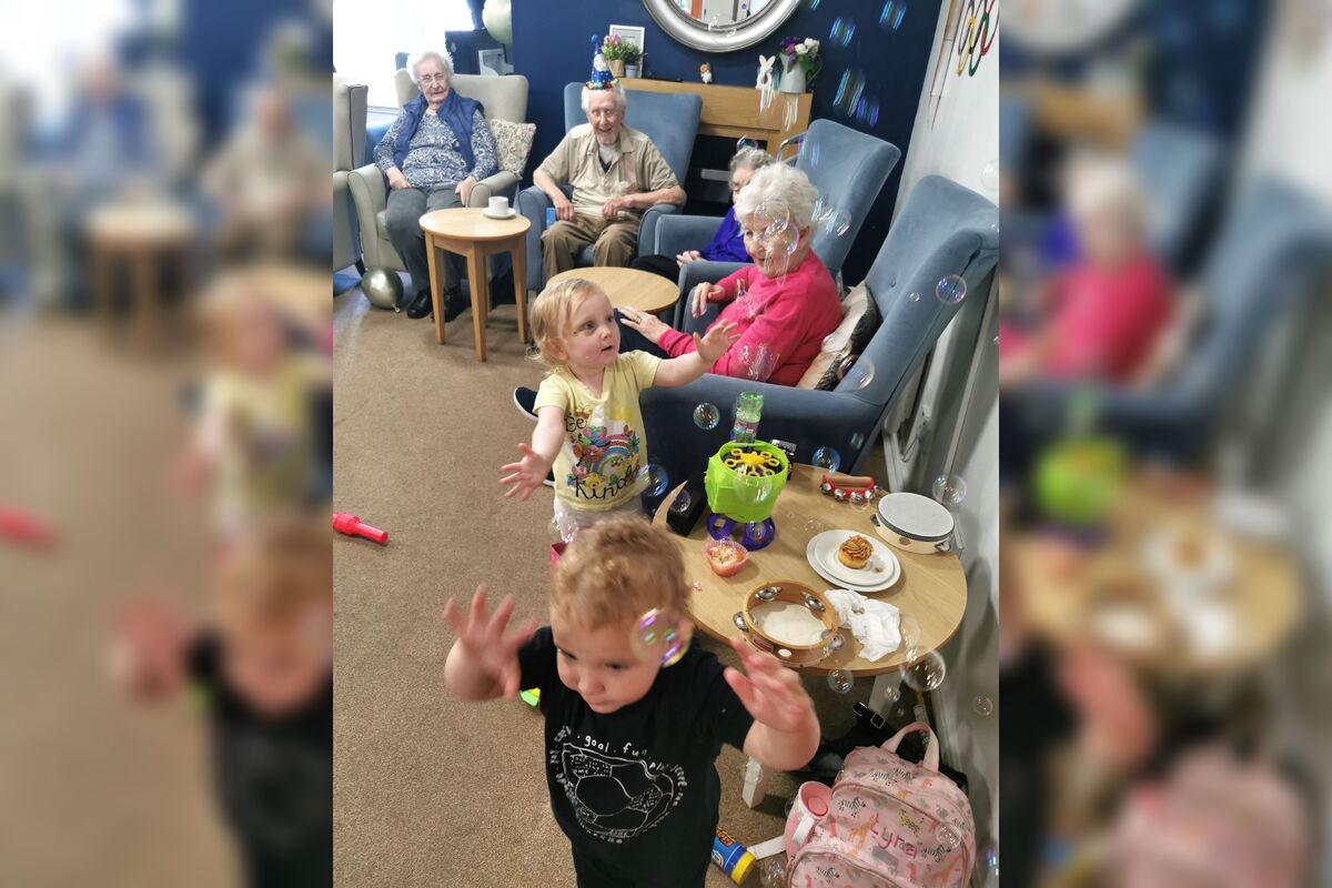 Joshua Ellis and Lyra Nelson having fun with residents during one of the playgroup sessions.