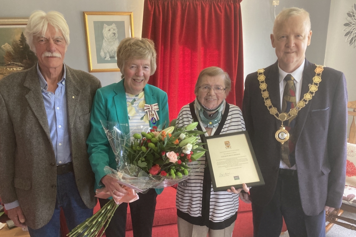 Andy Buntin, Jane MacLeod and Provost Dougie Philand presenting Betty Rhodick, second right, with her certificate at home in Lochgilphead. Photograph: Rita Campbell