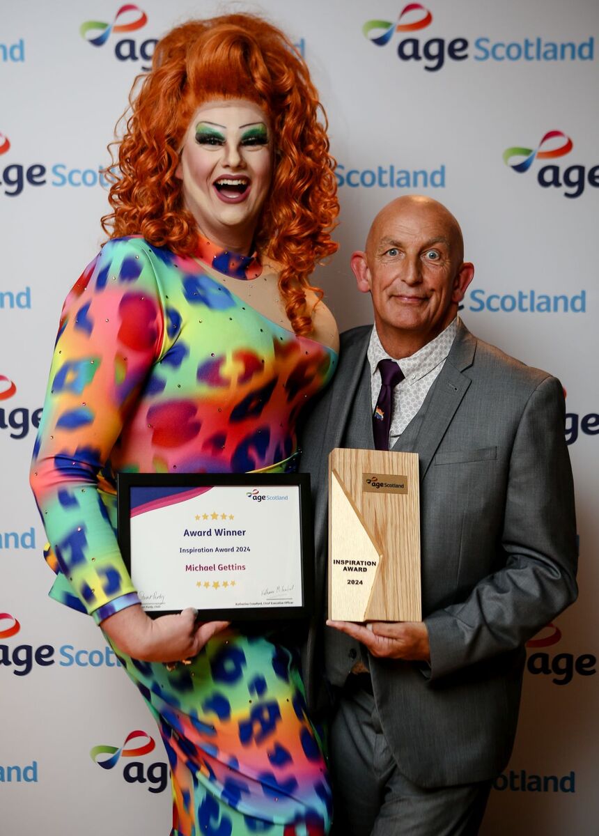 Michael Gettins with his Age Scotland Inspiration award, alongside Miss Sasha Blaze.