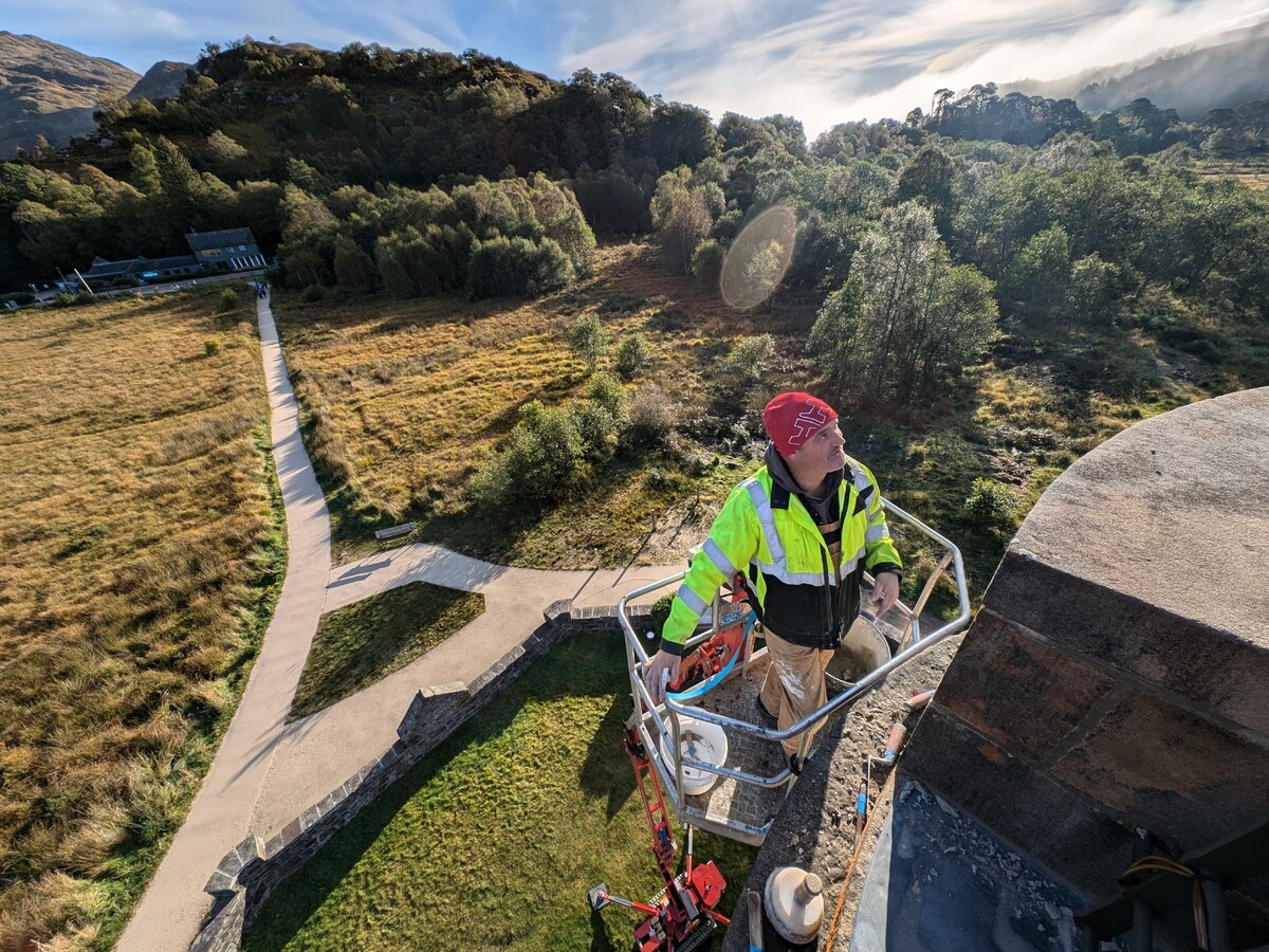 Skilled stonemason Andy Allan of Harper & Allan works at the top of the tower.