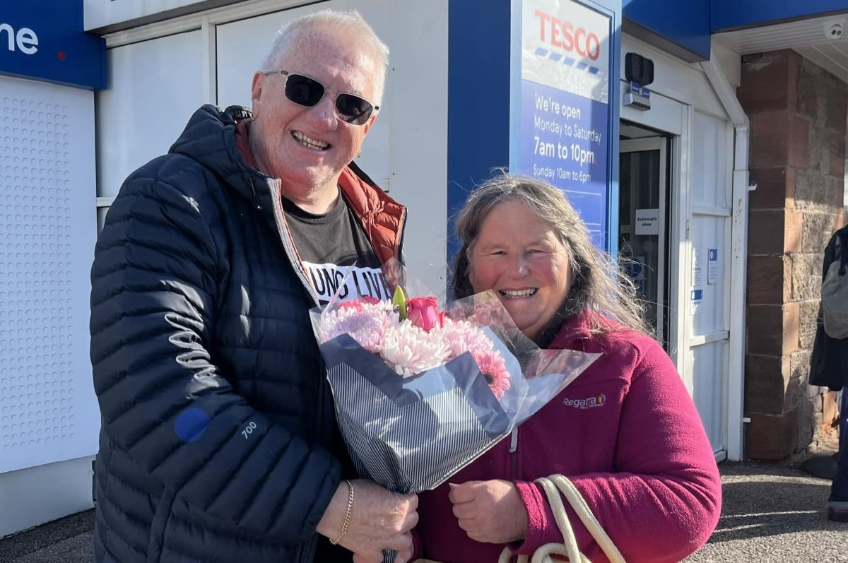 Iain McKerral, one of the group’s admins, presenting 5,000th member Susan Paterson with some congratulatory flowers.