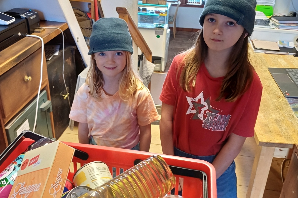 Lily and Ellie Grafton with the goods they were able to buy for the foodbank with their fund-raising. Photograph: Nicholas Mes