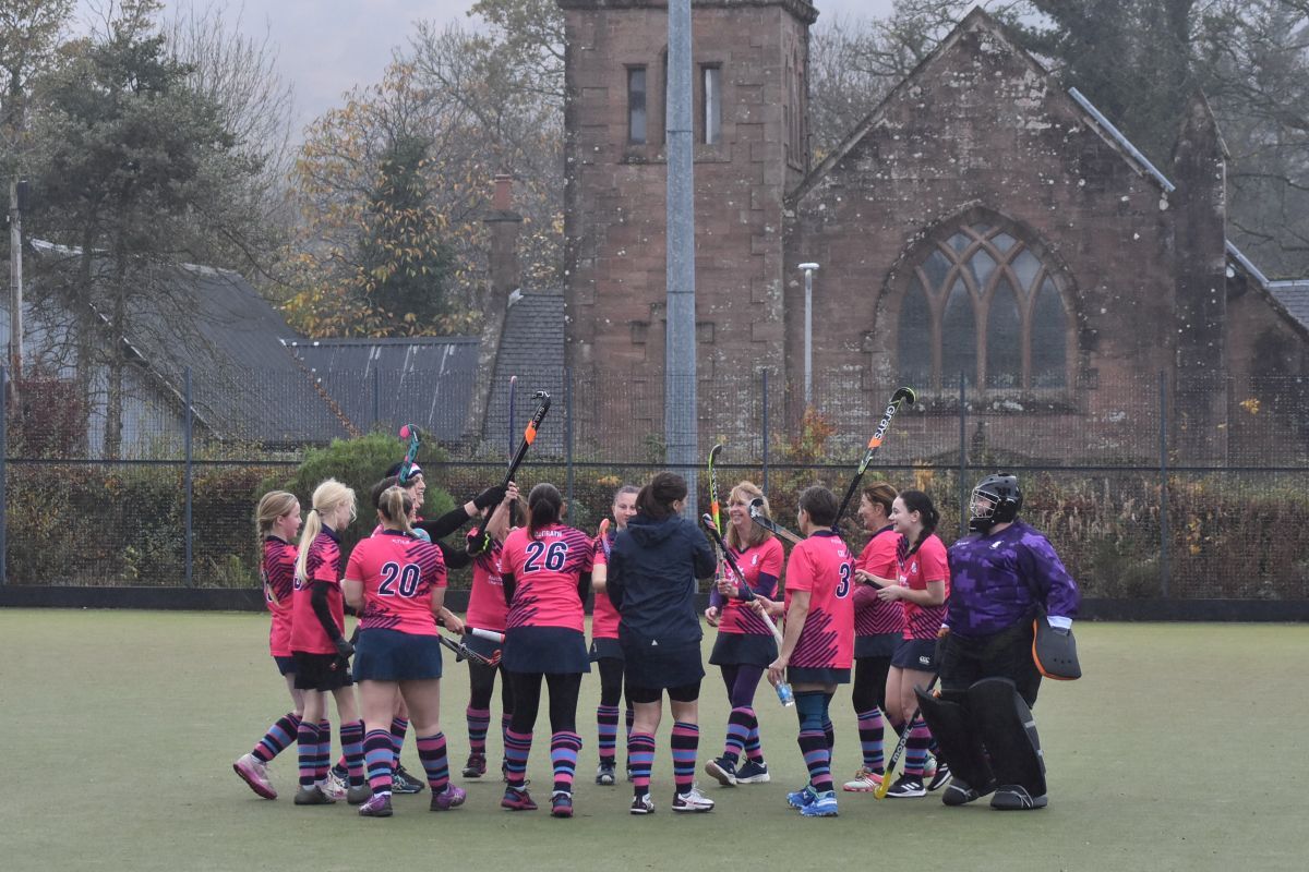 Arran Ladies share a laugh in the team huddle before the match.