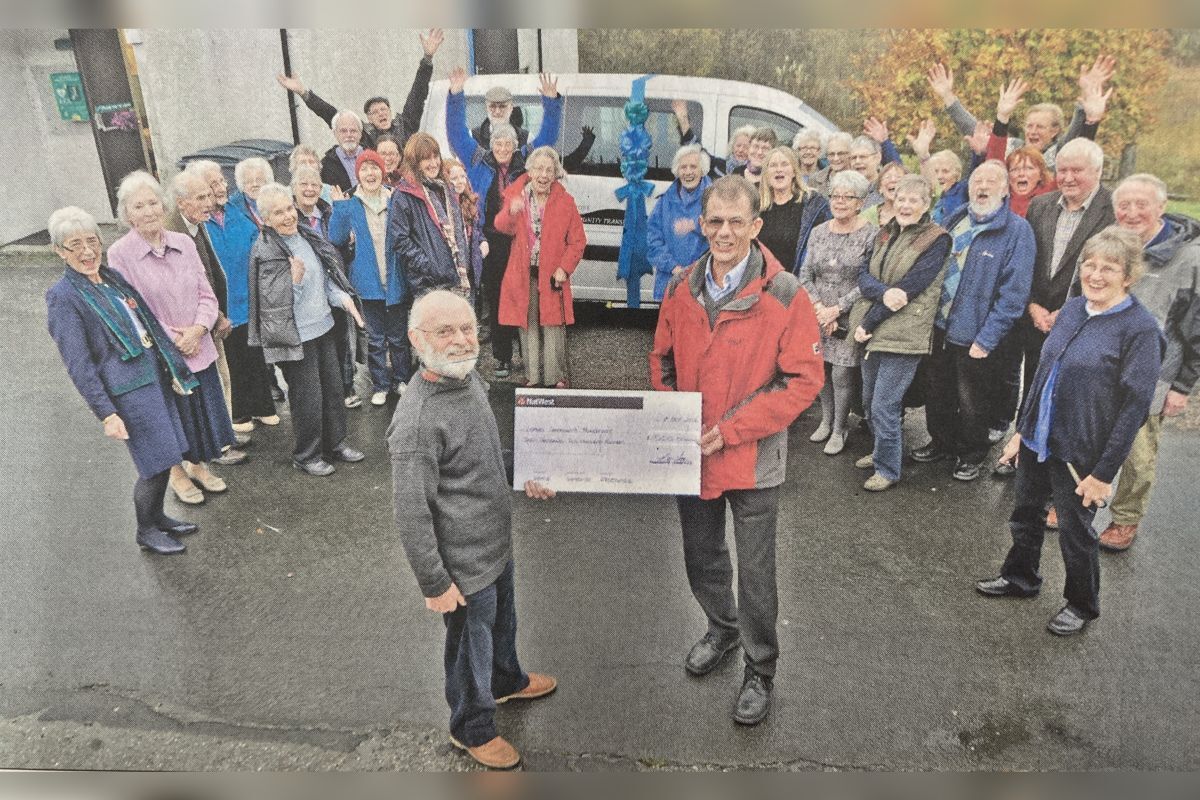 2014: Lismore Community Transport chairman Julian Wormleighton (left) receives a cheque from Glensanda quarry’s David Lamb as islanders welcome the new bus.