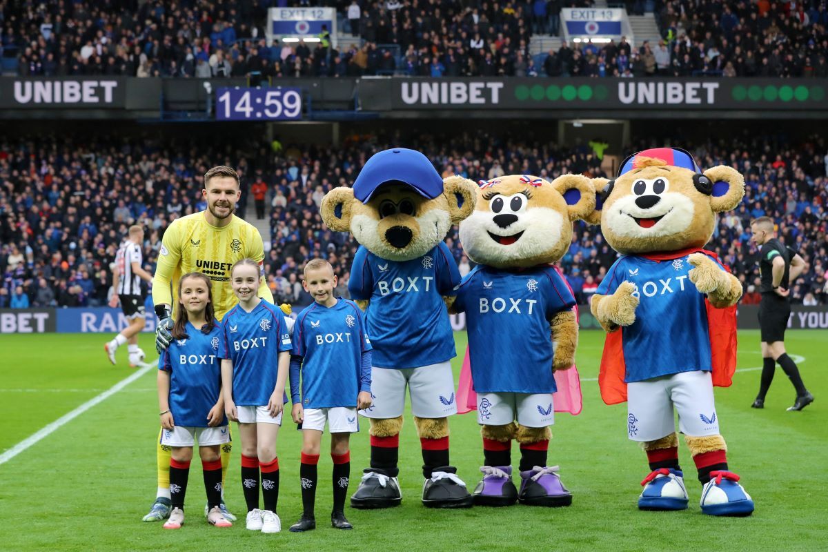 Young football fan rubs shoulders with sporting heroes