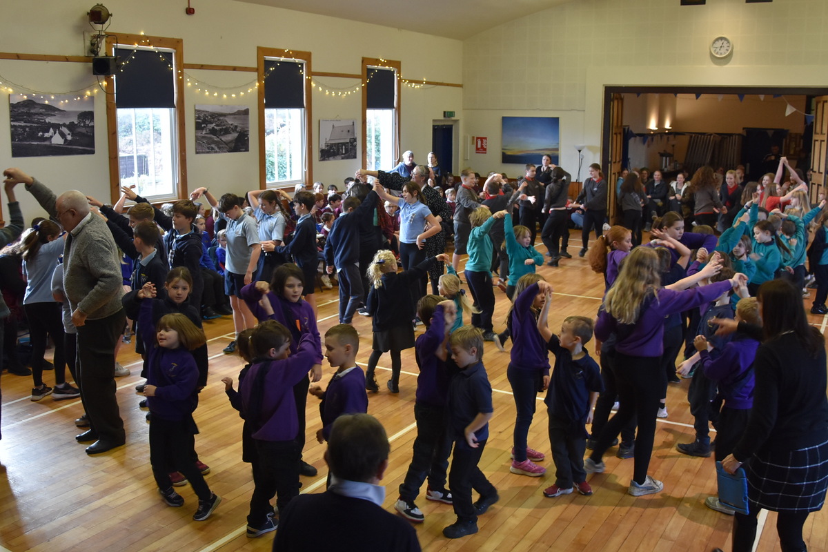 Pupils enjoy dancing while teachers provide guidance and their friends cheer them on from the sidelines.