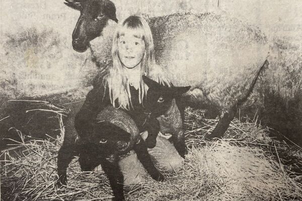 1984: Winter may be coming on but some sheep do not seem to realise it. Here, seven-year-old Fiona Robb, of Eurach Farm, Kilmartin, is pictured with two surprise cuddly bundles - twin Suffolk lambs born out of season on November 10. 