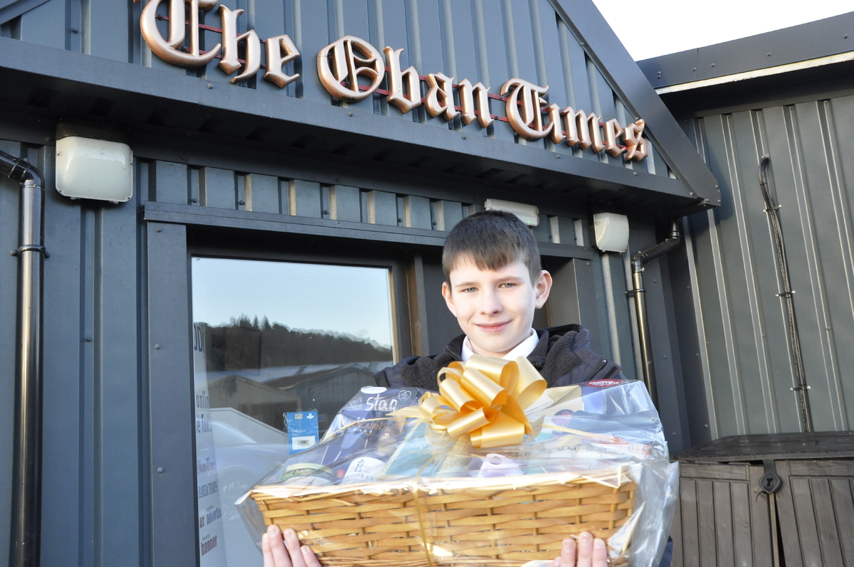 Alexander Maxwell with the luxury Scottish Field hamper he won in a photographic competition capturing the magic of this year's Oban Winter Festival