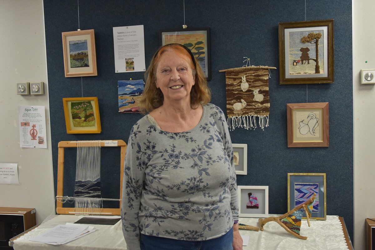 Tapestry weaver Jo Morgan with some of her tapestries on display at Arran Library.